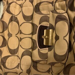 Authentic unique pre loved with care shoulder strap Coach purse with large logo.
